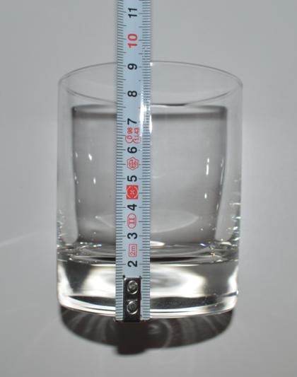 Imagen de la medición de la altura de un vaso de cristal cilíndrico Imagen de la medición de la altura de un vaso de cristal cilíndrico