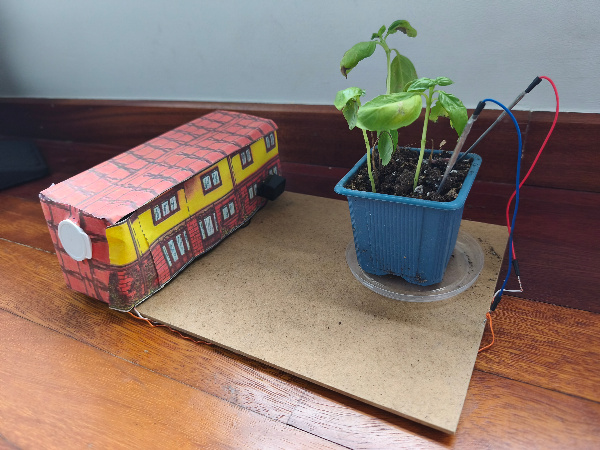 En la imagen se presenta una maqueta de un proyecto con un sensor de humedad para detectar riego de agua en una planata