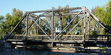Truss bridge for a single track railway, converted to pedestrian use and pipeline support