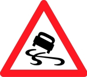 Señal de tráfico indicadora de peligro. Triángulo rojo con un dibujo en color negro de un coche derrapando en el interior del triángulo.
