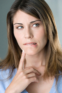 Imagen de una chica rubia de pelo a la altura de los hombos. Tiene un dedo de su mano apoyado en el mentón y hace una mueca co n el labio simulando que está decidiendo sobre algo.